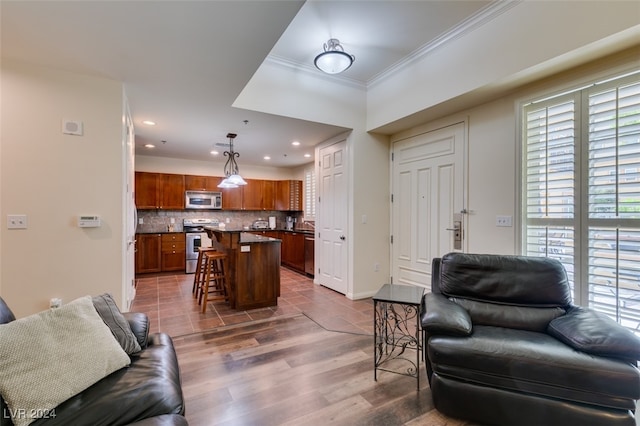 living room featuring ornamental molding and dark hardwood / wood-style floors