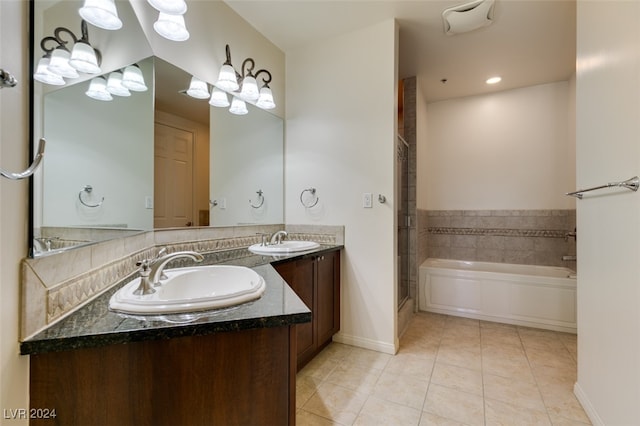 bathroom featuring vanity, a bath, and tile patterned flooring