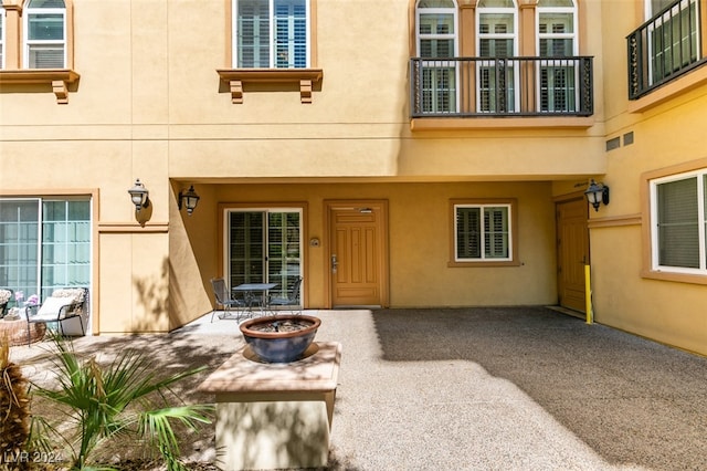 doorway to property featuring a patio and a balcony