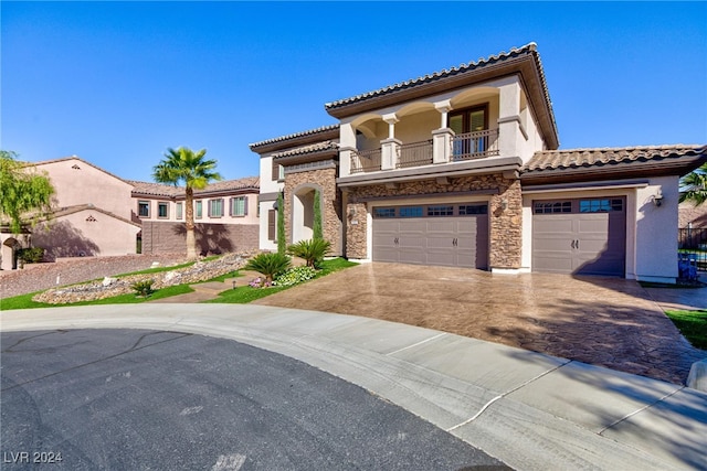 mediterranean / spanish home with a balcony and a garage