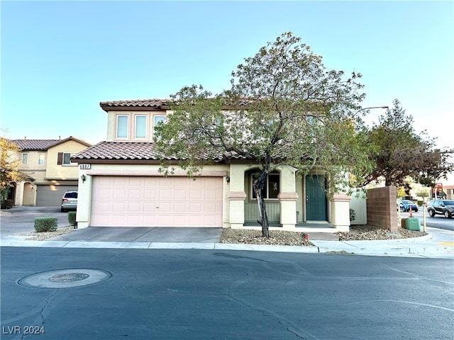 mediterranean / spanish house with a garage