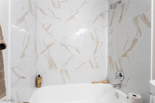 bathroom featuring tile walls and tub / shower combination