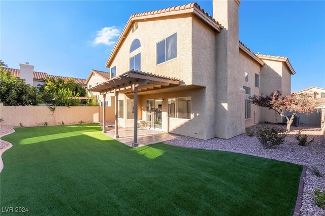 back of property featuring a pergola, a patio, and a lawn