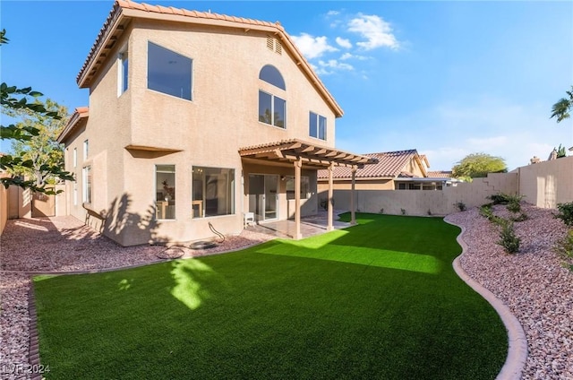 back of property featuring a lawn and a patio area