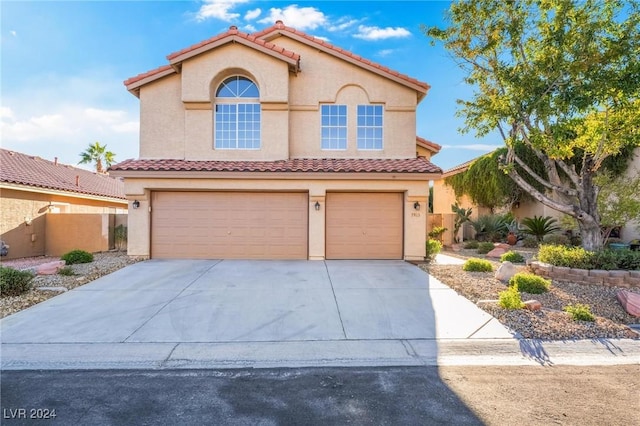 mediterranean / spanish-style home with a garage