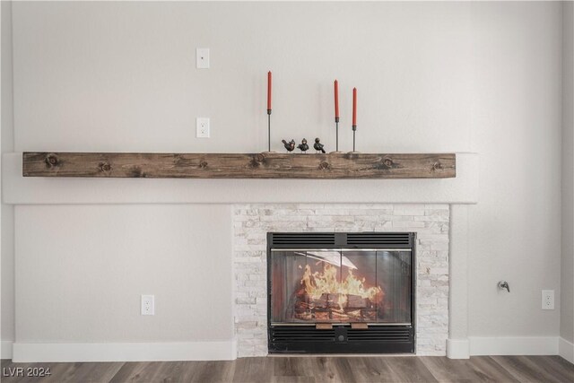 details with a fireplace and wood-type flooring