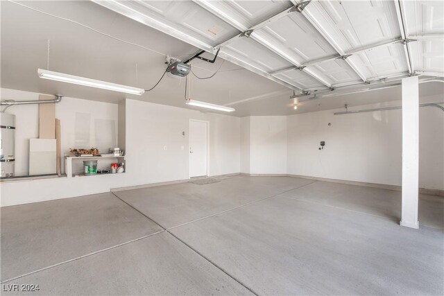 garage featuring water heater and a garage door opener