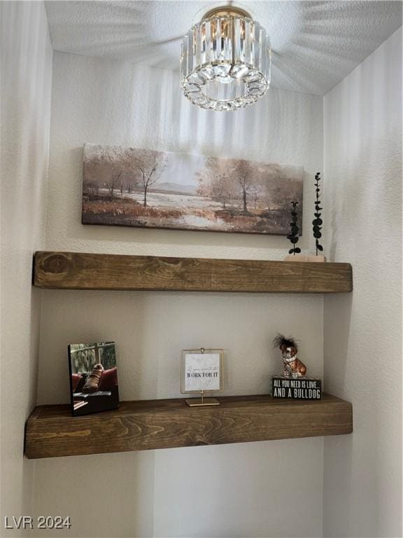 interior details featuring an inviting chandelier