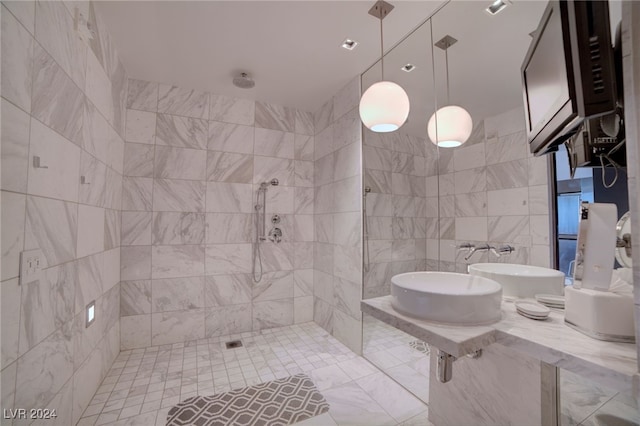 bathroom featuring tile walls and a tile shower