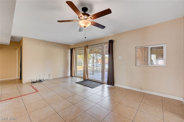 spare room with light tile patterned floors and ceiling fan