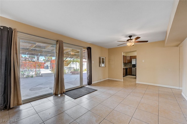 doorway to outside with ceiling fan and light tile patterned floors