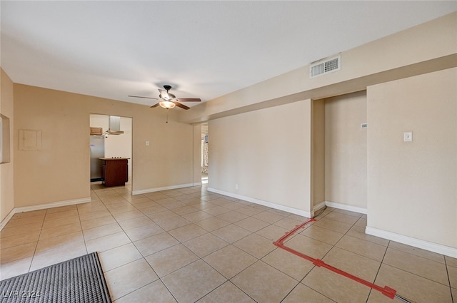 spare room with ceiling fan and light tile patterned flooring