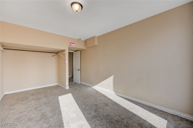 unfurnished bedroom featuring carpet flooring and a closet