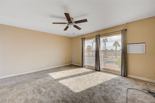 carpeted empty room featuring ceiling fan