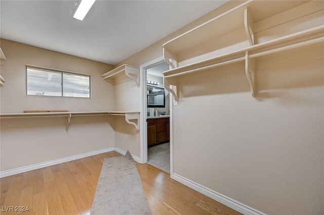 spacious closet with light hardwood / wood-style flooring