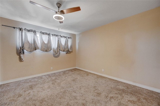 spare room featuring ceiling fan and carpet floors