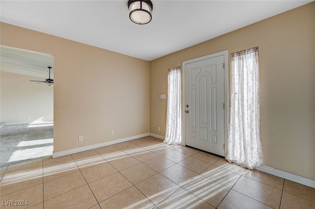 foyer entrance with ceiling fan and light tile patterned floors