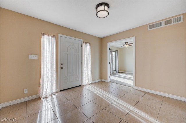 foyer with ceiling fan and light tile patterned flooring