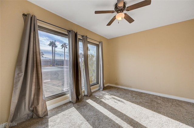 empty room with ceiling fan and carpet floors