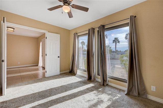 unfurnished room with light carpet and ceiling fan