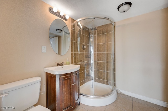 bathroom with toilet, vanity, tile patterned floors, and an enclosed shower