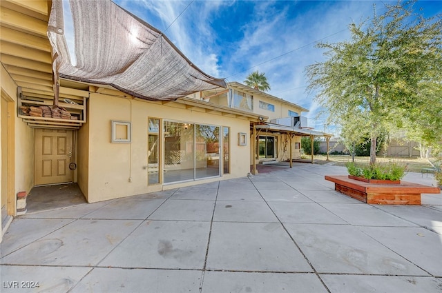 back of house with a patio