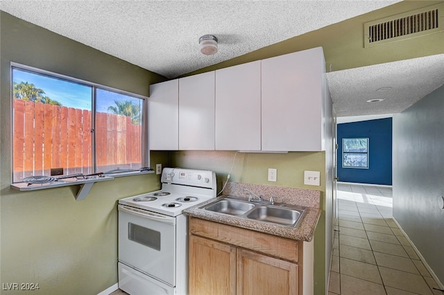 kitchen with white cabinetry, sink, white electric stove, a textured ceiling, and light tile patterned floors