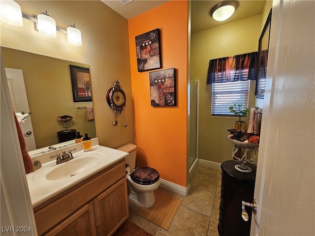 bathroom with vanity, walk in shower, tile patterned floors, and toilet