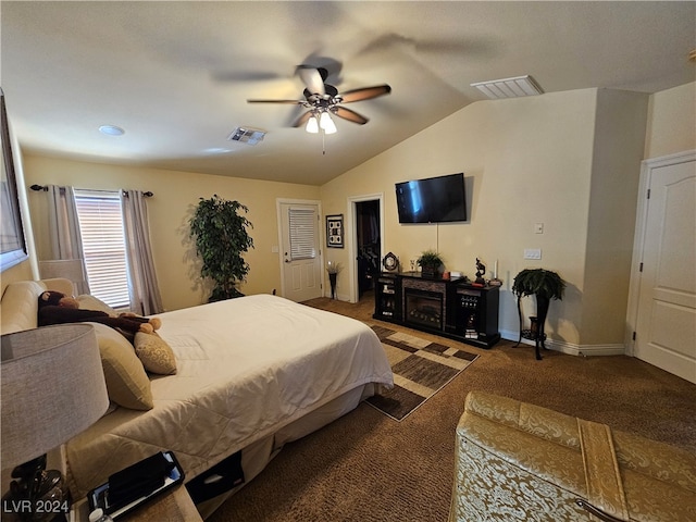 bedroom with ceiling fan, vaulted ceiling, and dark carpet