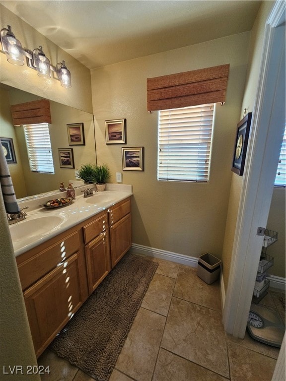 bathroom featuring vanity, tile patterned floors, and a healthy amount of sunlight