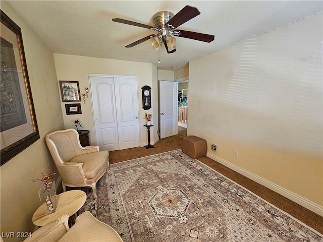 sitting room featuring carpet and ceiling fan