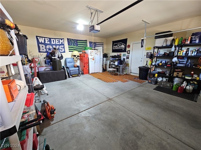 garage featuring a garage door opener and white refrigerator