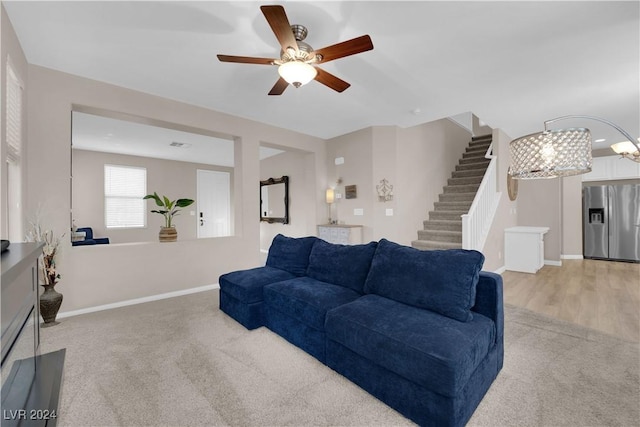 living room featuring ceiling fan and hardwood / wood-style flooring