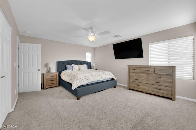 bedroom with light colored carpet and ceiling fan