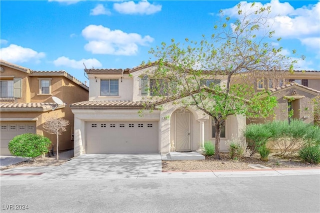 mediterranean / spanish house with a garage