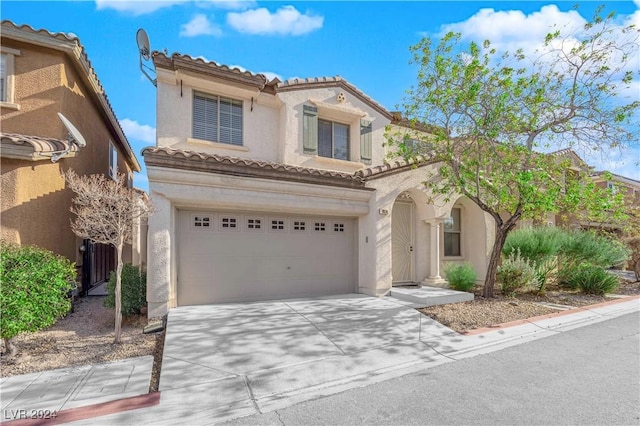 mediterranean / spanish home featuring a garage