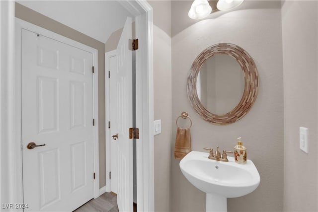 bathroom with hardwood / wood-style floors and sink