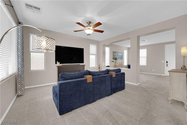 living room with light carpet and ceiling fan