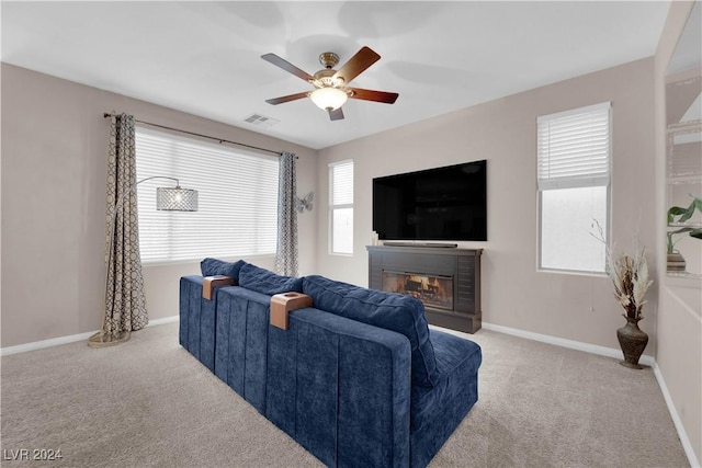 living room featuring light carpet and ceiling fan