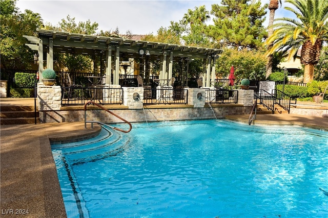 view of swimming pool with a pergola, a patio area, and pool water feature