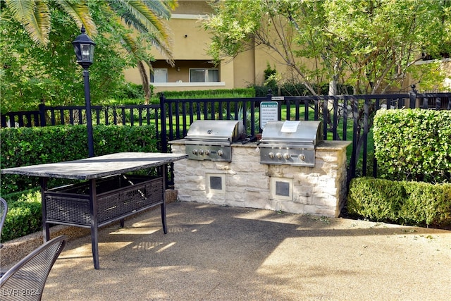 view of patio / terrace featuring an outdoor kitchen and a grill