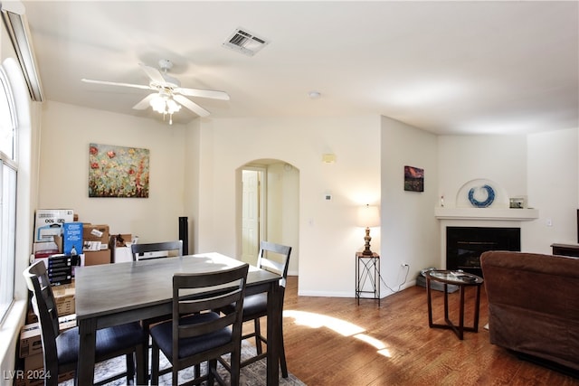 dining area with ceiling fan and wood-type flooring