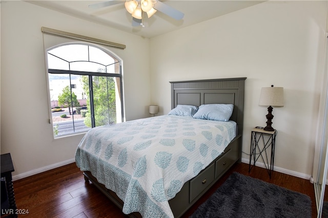 bedroom with ceiling fan and dark hardwood / wood-style floors