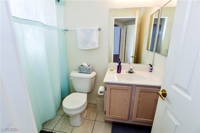 bathroom featuring toilet, vanity, and tile patterned floors