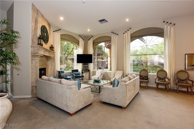 living room with carpet flooring and a tiled fireplace