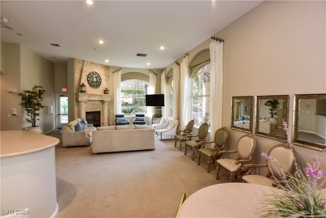 living room with light carpet and a fireplace