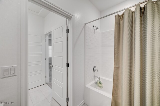 bathroom with tile patterned flooring and shower / tub combo