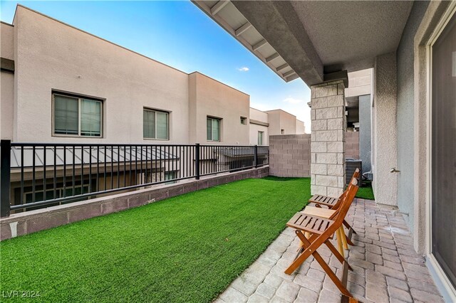 view of yard with central air condition unit and a patio area