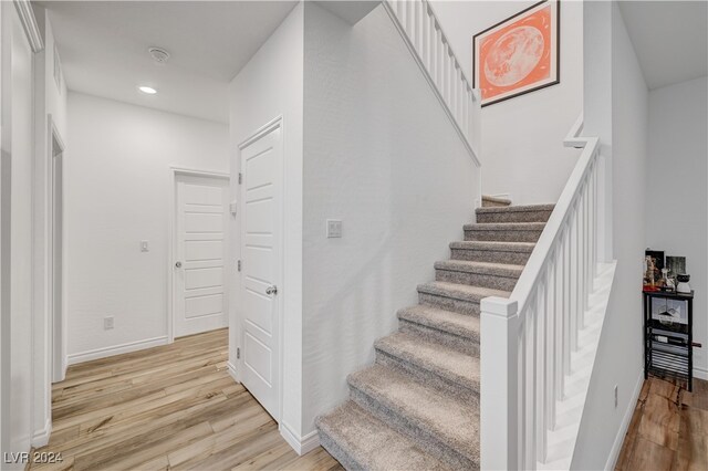 stairs with hardwood / wood-style flooring