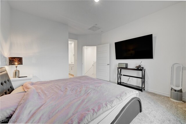 carpeted bedroom with ensuite bathroom